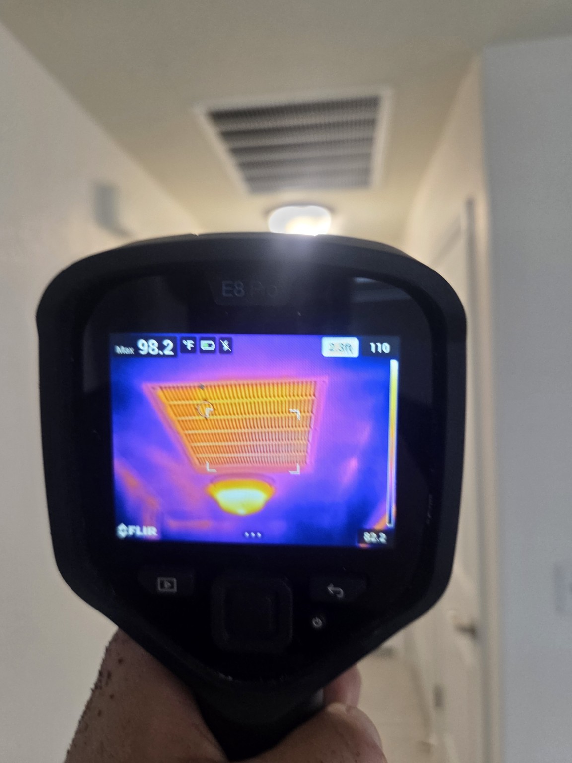Thermal camera used to examine temperature patterns at a ceiling register