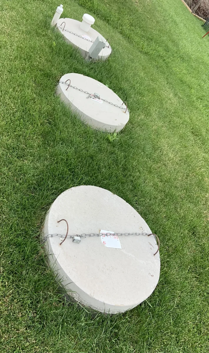 Septic tank access covers in a lawn