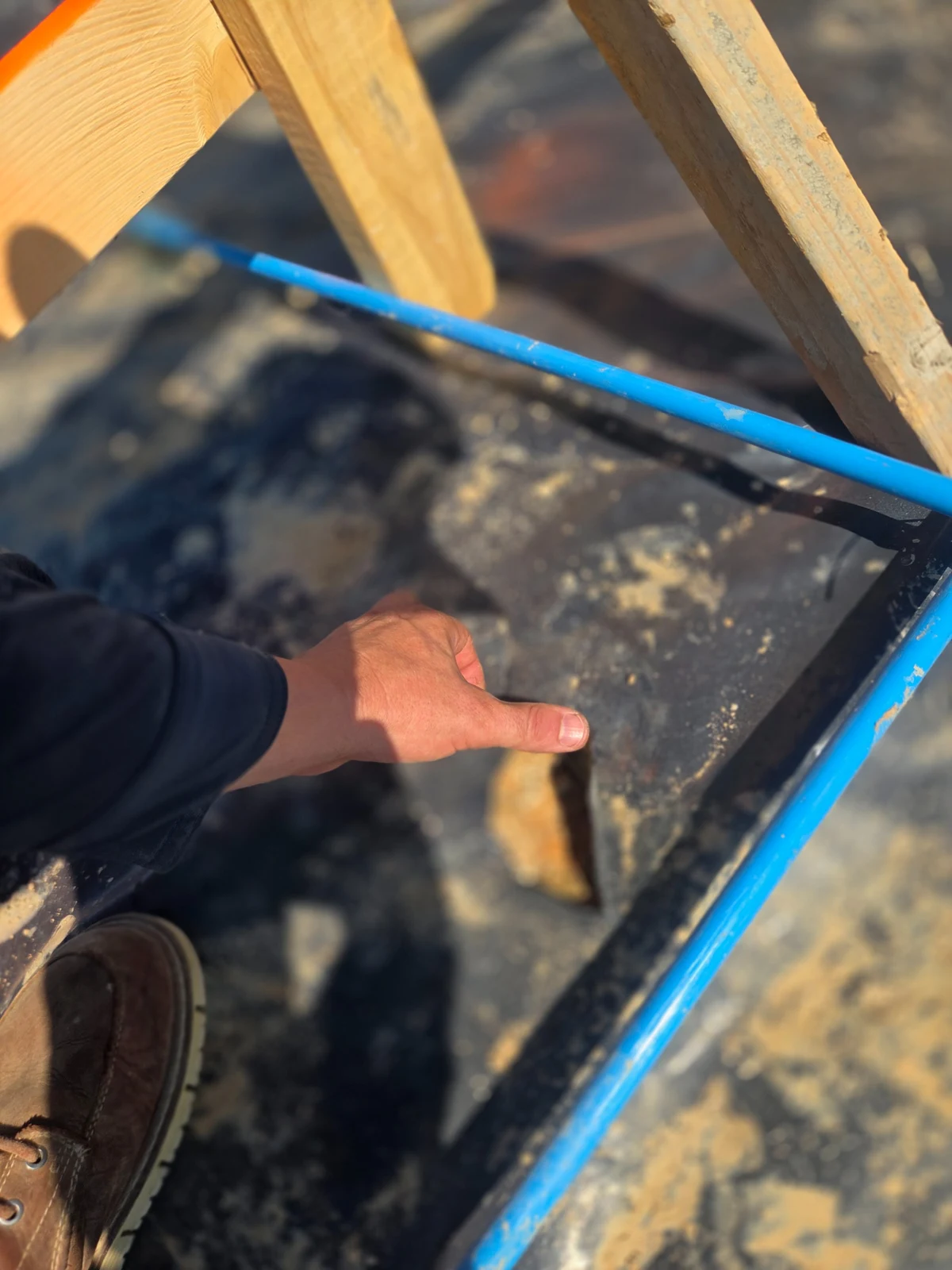 Damaged vapor retarder photographed during a pre-pour inspection