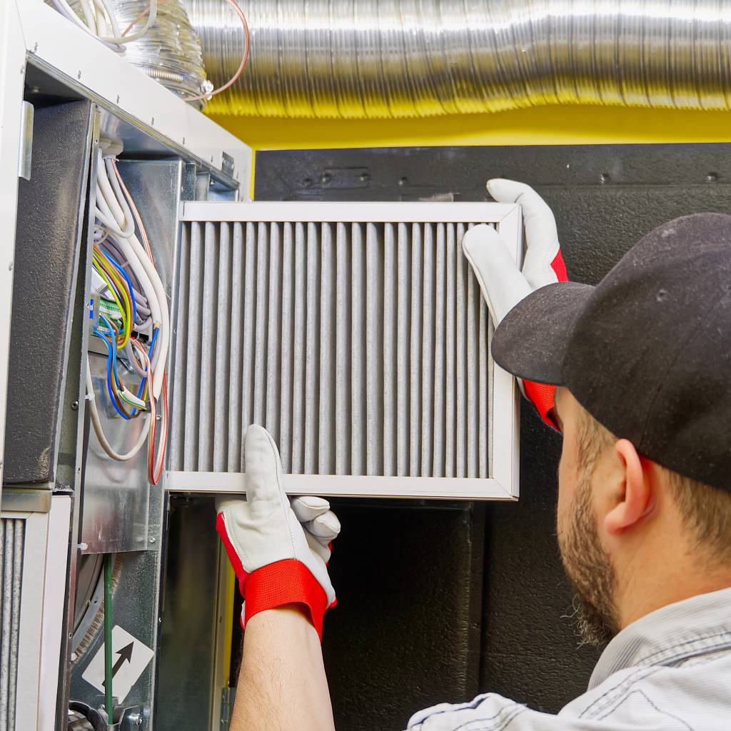Home inspector checking hvac filter for proper airflow and performance