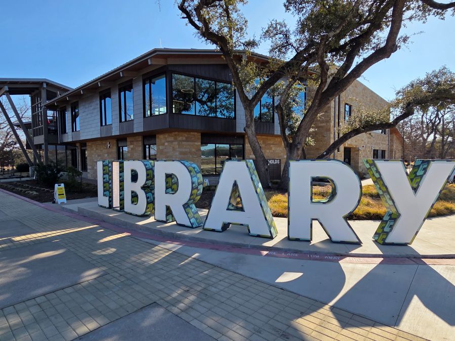 Large LIBRARY letters outside Cedar Park Public Library at the Bell District