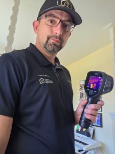 home inspector using a thermal imaging device from FLIR