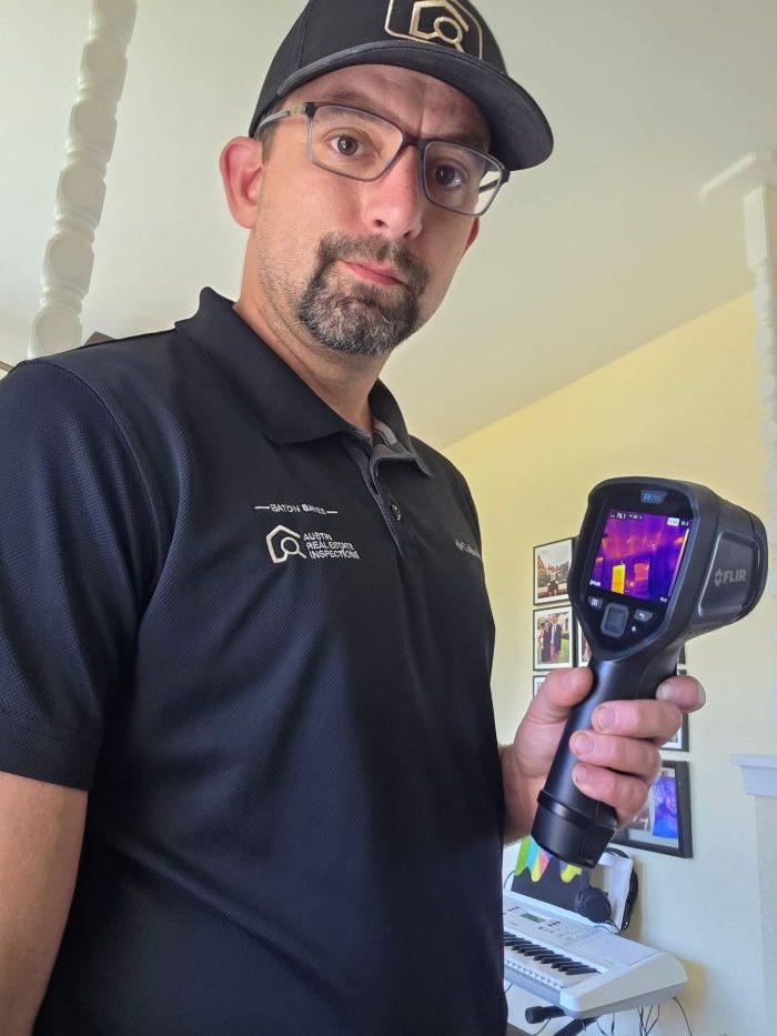 home inspector using a thermal imaging device from FLIR