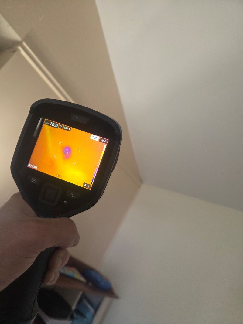 FLIR camera displaying a cooler spot while scanning a ceiling.