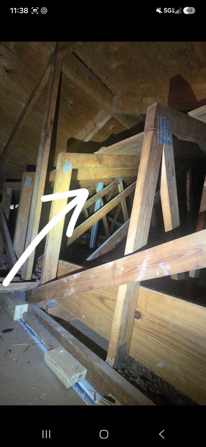 Attic view with an arrow pointing toward the dryer vent