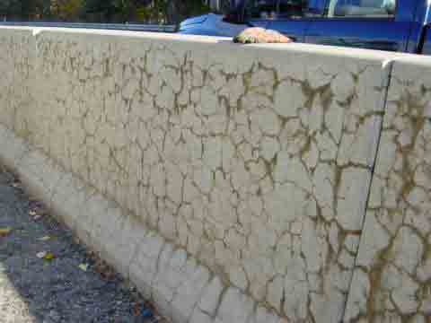 Network of map cracks in a concrete highway barrier, shown as an educational example from FHWA’s ASR guidance.