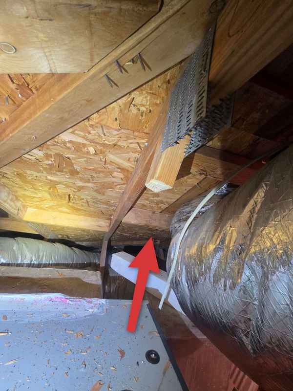 Second cut roof-truss member beside attic ductwork