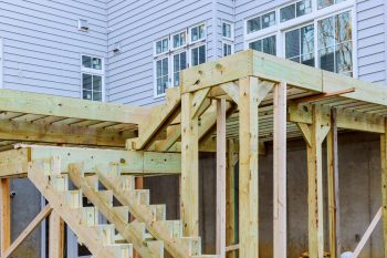 Deck construction in an Austin home showing framing and ledger attachment