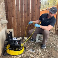 Home inspector Eaton Bates performing a Leander sewer scope inspection